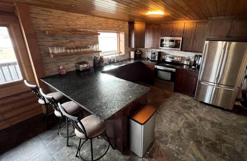 Ennis House | Scenic Vacation Home with Wrap-Around Deck Overlooking Ennis Lake near McAllister, Montana