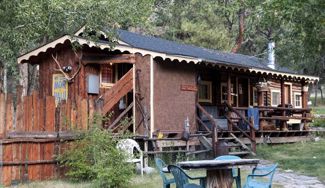 Rustic Log Cabin Set Within Mountains in Colorado